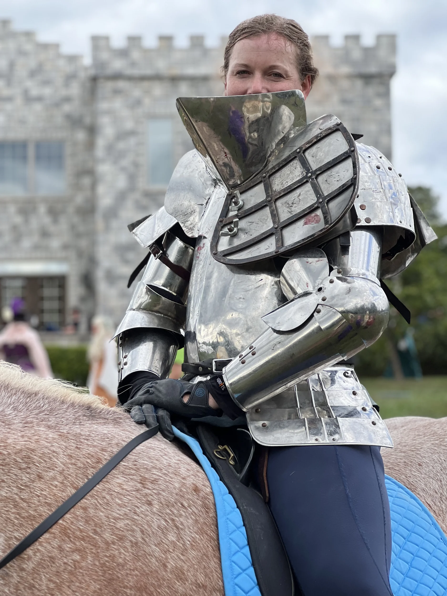 lady knight on horseback in front of castle